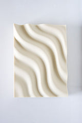 A Utilize Studios Ripple Soap Tray with printed waves on it.