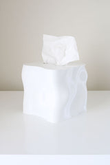 An Ebb Tissue Box, made from recycled plastic and inspired by the ocean, sits on top of a table.