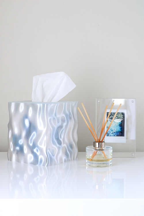 Wider view of the clear Flow cover with a reed diffuser and framed photo