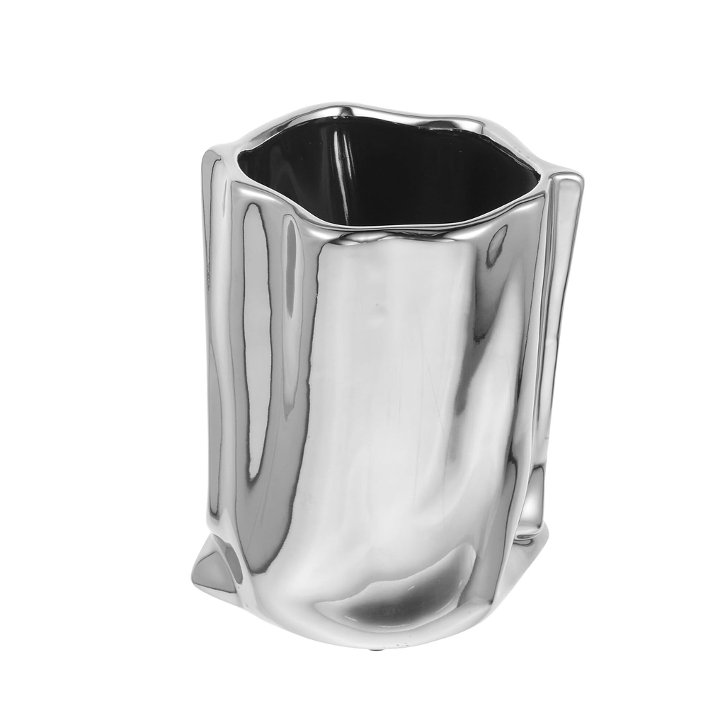 Metallic bag vase in silver, crinkled paper bag shape, on a plain background