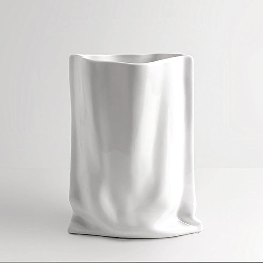 Bag vase in a matte white finish on a pale grey background