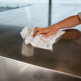 Reusable bamboo towel wiping a kitchen bench, washable paper towel alternative