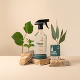 Bathroom reusable glass spray bottle with silicone base beside a basin