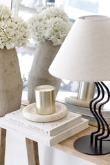 Bay round travertine tray used as bedside styling base with lamp and decor
