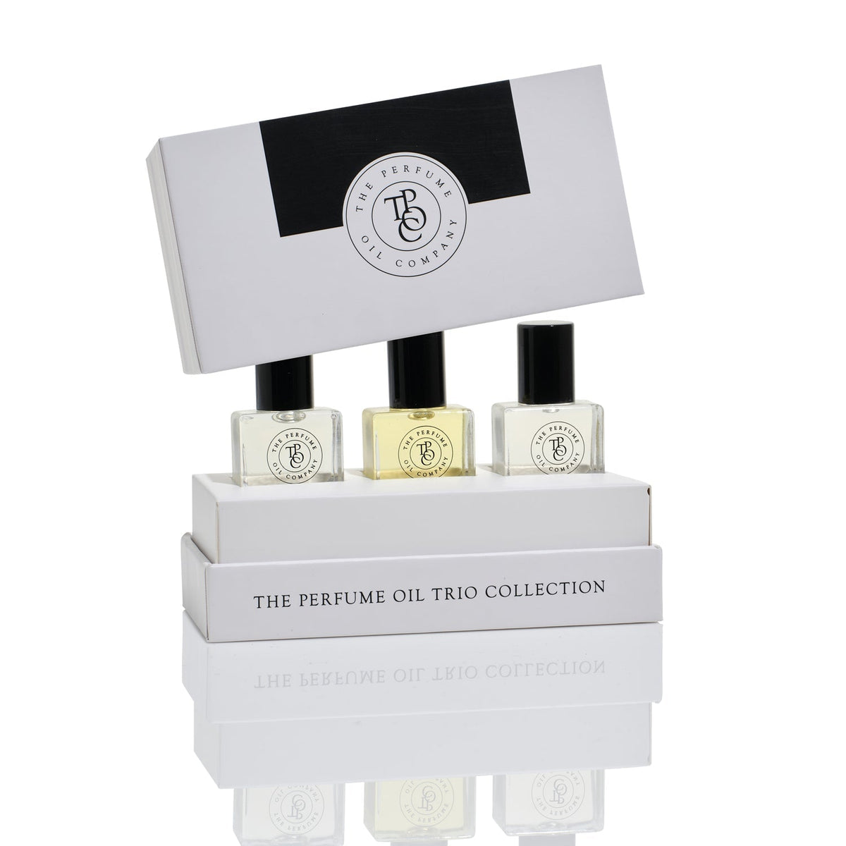 Trio collection gift box with the lid lifted and three roll-on perfume oil bottles in front