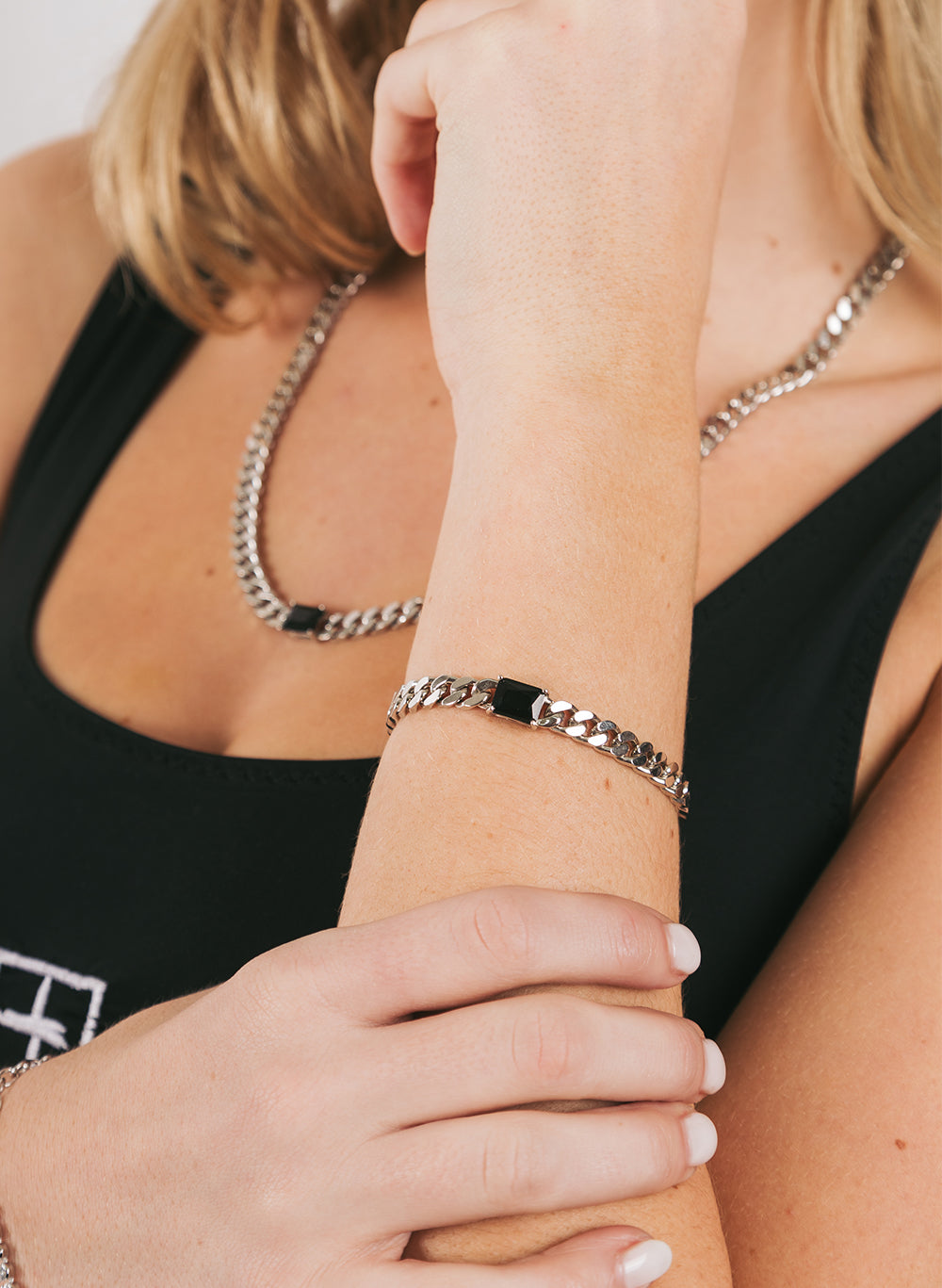Big Chain Bracelet worn on a raised wrist, matching curb chain at the neck