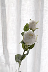 Realistic artificial Bordeaux peony stem in aged white with soft layered petals and green leaves, styled against a light background.