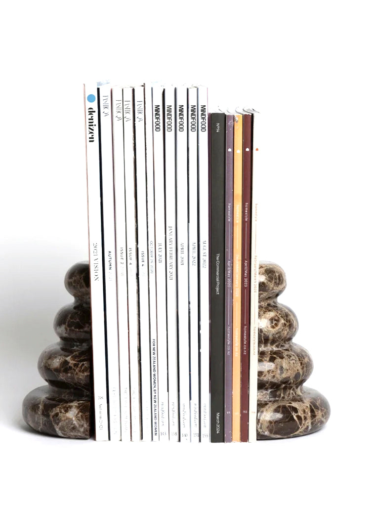 Casa bookends holding a row of magazines, on white