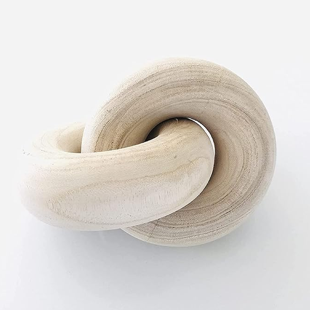 Close view of the natural wood knot sculpture, showing the carved growth rings