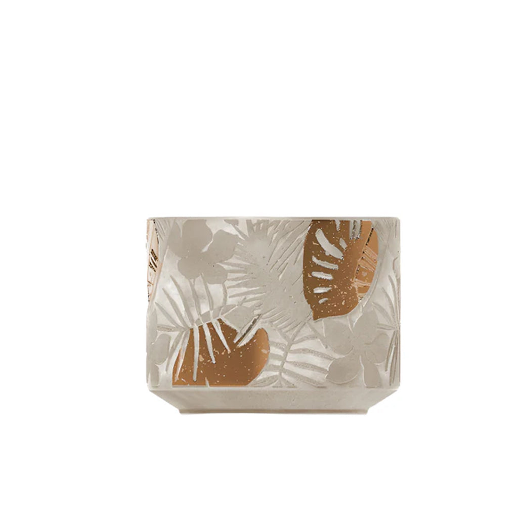 Therapy Garden outdoor candle in a concrete vessel embossed with leaves and copper accents, on white