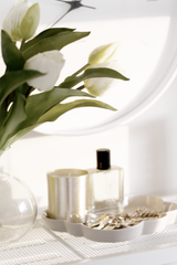 Cloud Jewellery Tray in cashmere stoneware styled with keys, a gold candle, perfume, and white tulips.