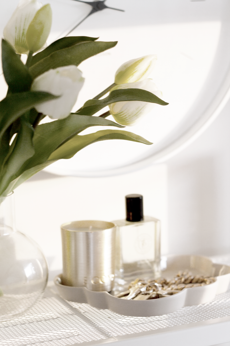 Cloud Jewellery Tray in cashmere stoneware styled with keys, a gold candle, perfume, and white tulips.