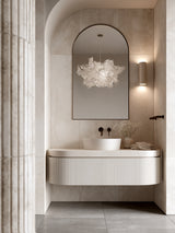 White Cloud Pendant paper lamp shade in a bathroom with an arched mirror and fluted timber vanity