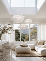 White Cloud Pendant paper lamp shade in a bright coastal living room with cream sofa and olive branches