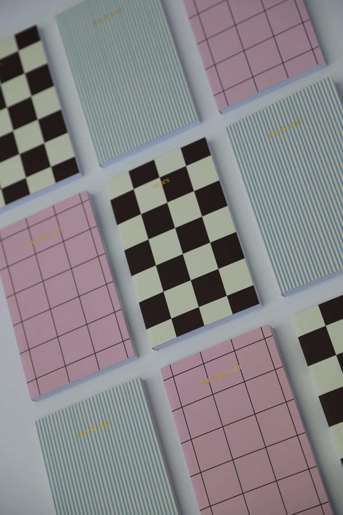 Papier HQ notebooks in blue stripe, check and pink grid designs laid out flat