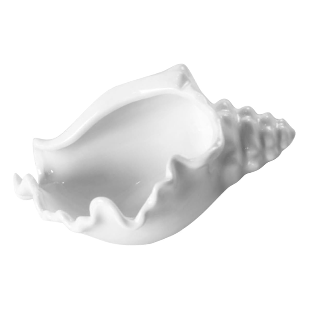 White ceramic conch shell bowl shown side on against white, the lipped opening facing the camera