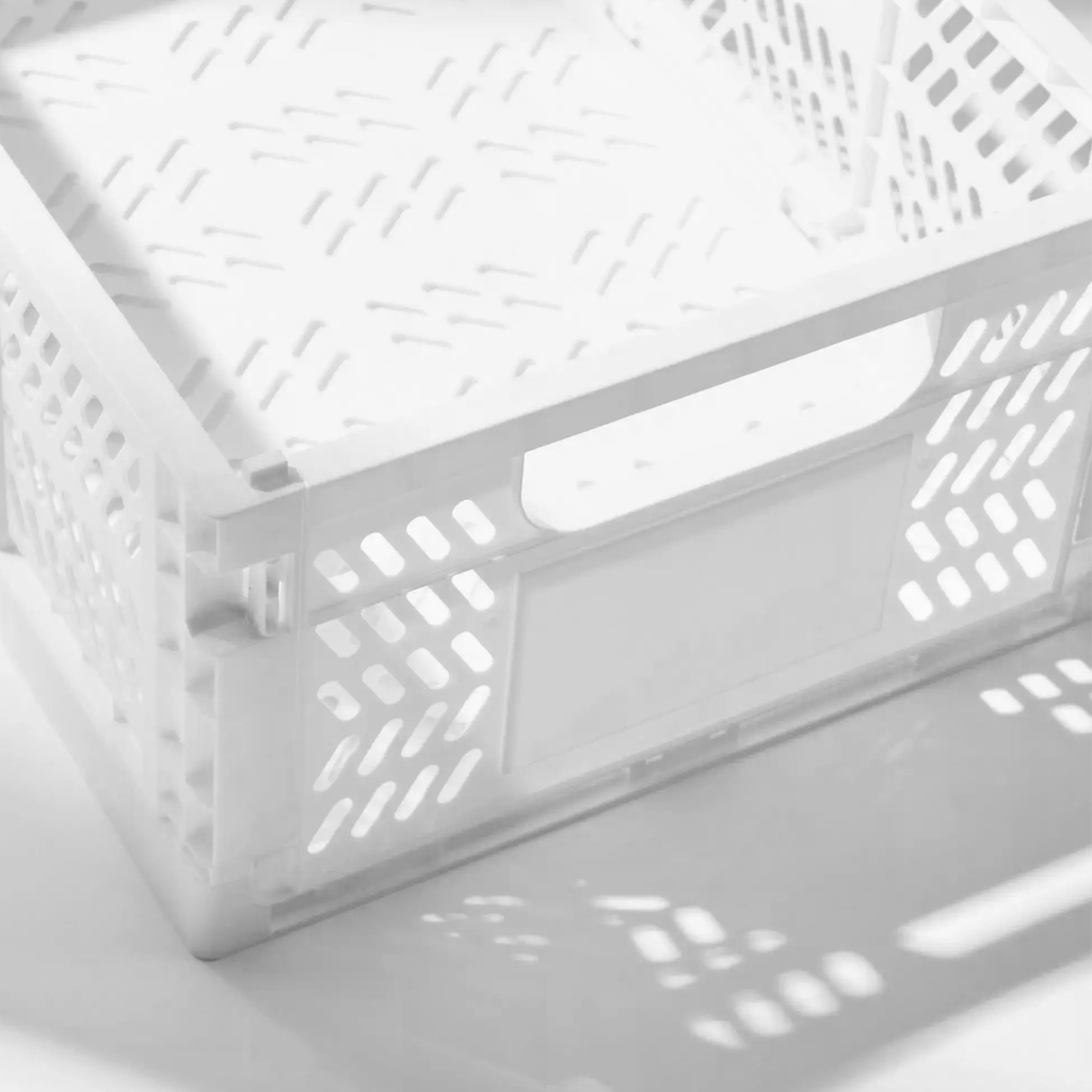 Close view of the crate's slotted side and moulded handle in bright light
