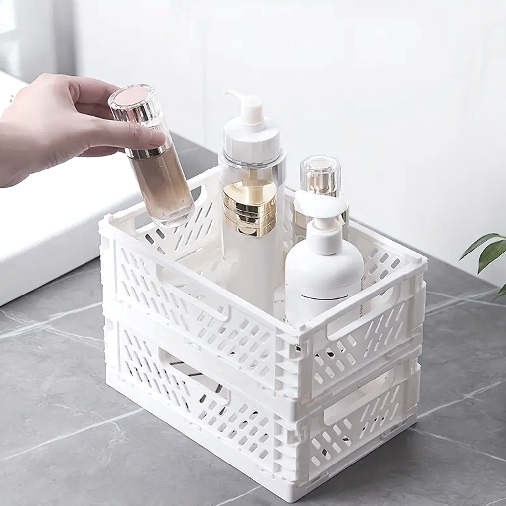 Two stacked white crates holding pump bottles on a tiled bathroom floor