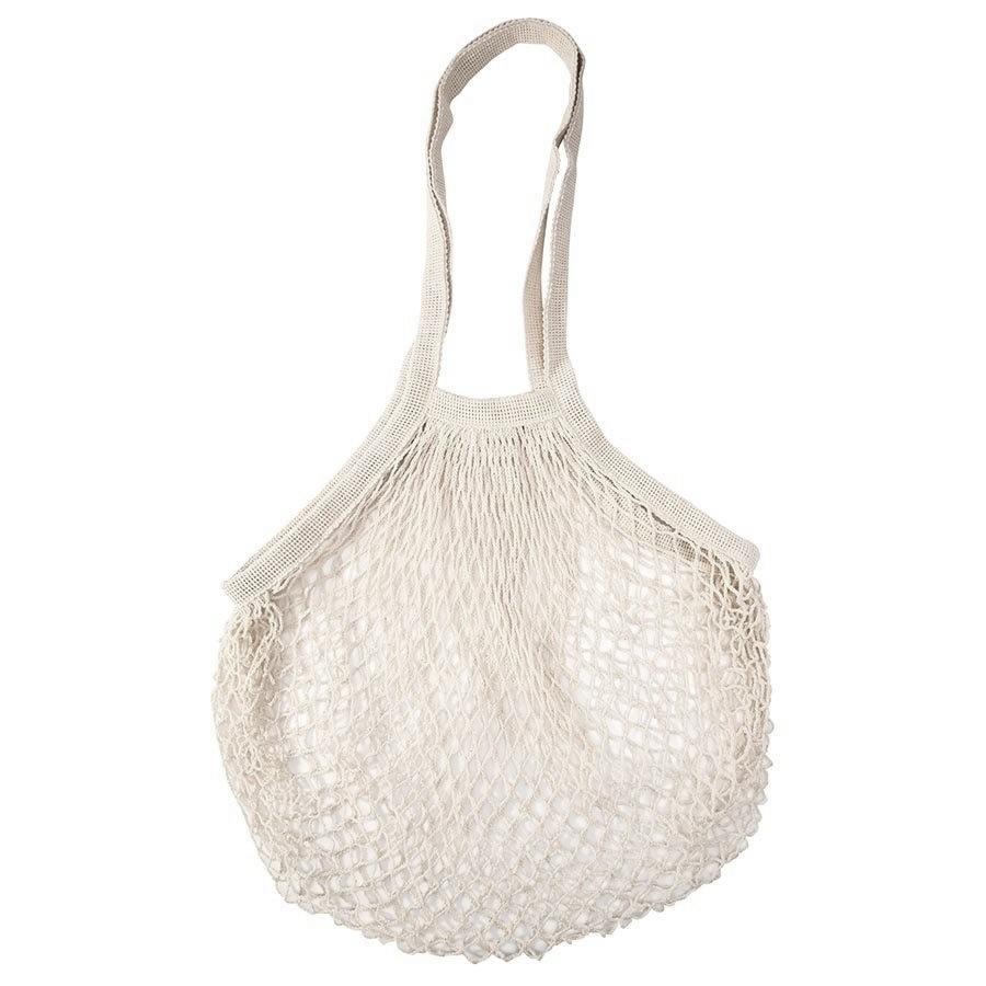 Cream cotton string market bag hanging empty by its short handle on a white background