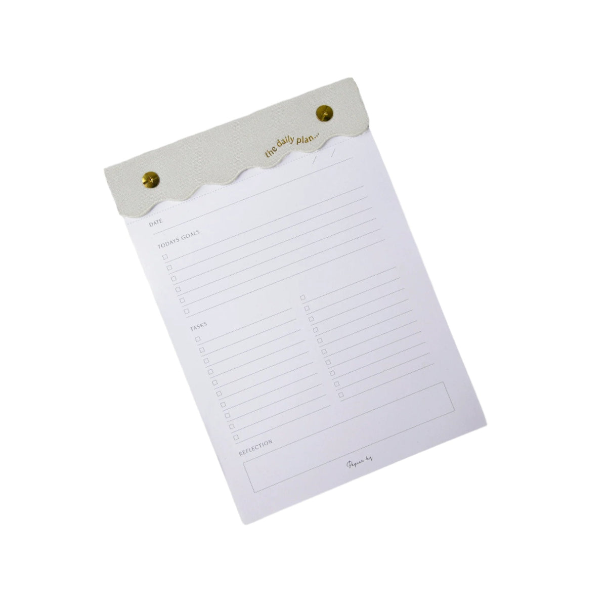 Curved daily notes pad with scalloped nude header and gold pins, angled on white