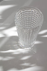 Clear glass with wavy pattern on a textured surface