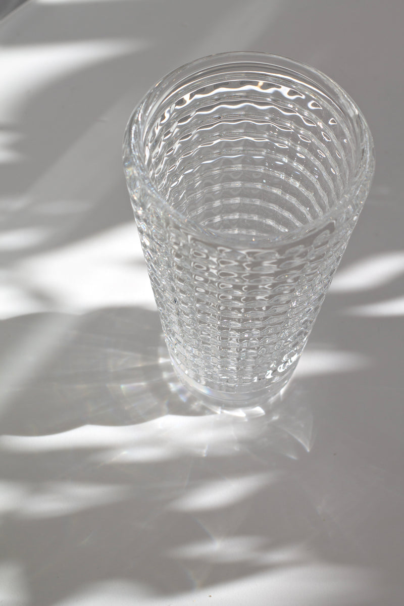 Clear glass with wavy pattern on a textured surface