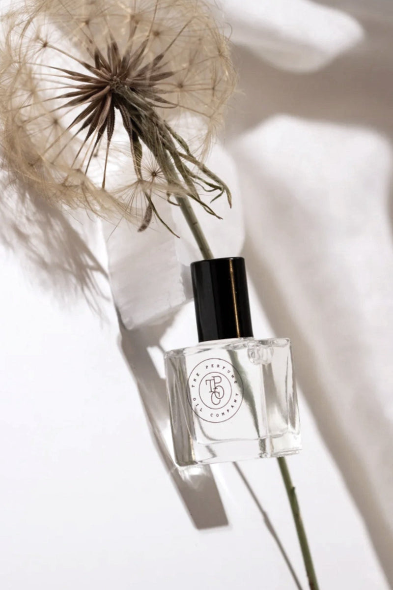 A The Perfume Oil Collection Gift Set - Floral bottle of perfume with a dandelion next to it from The Perfume Oil Company.