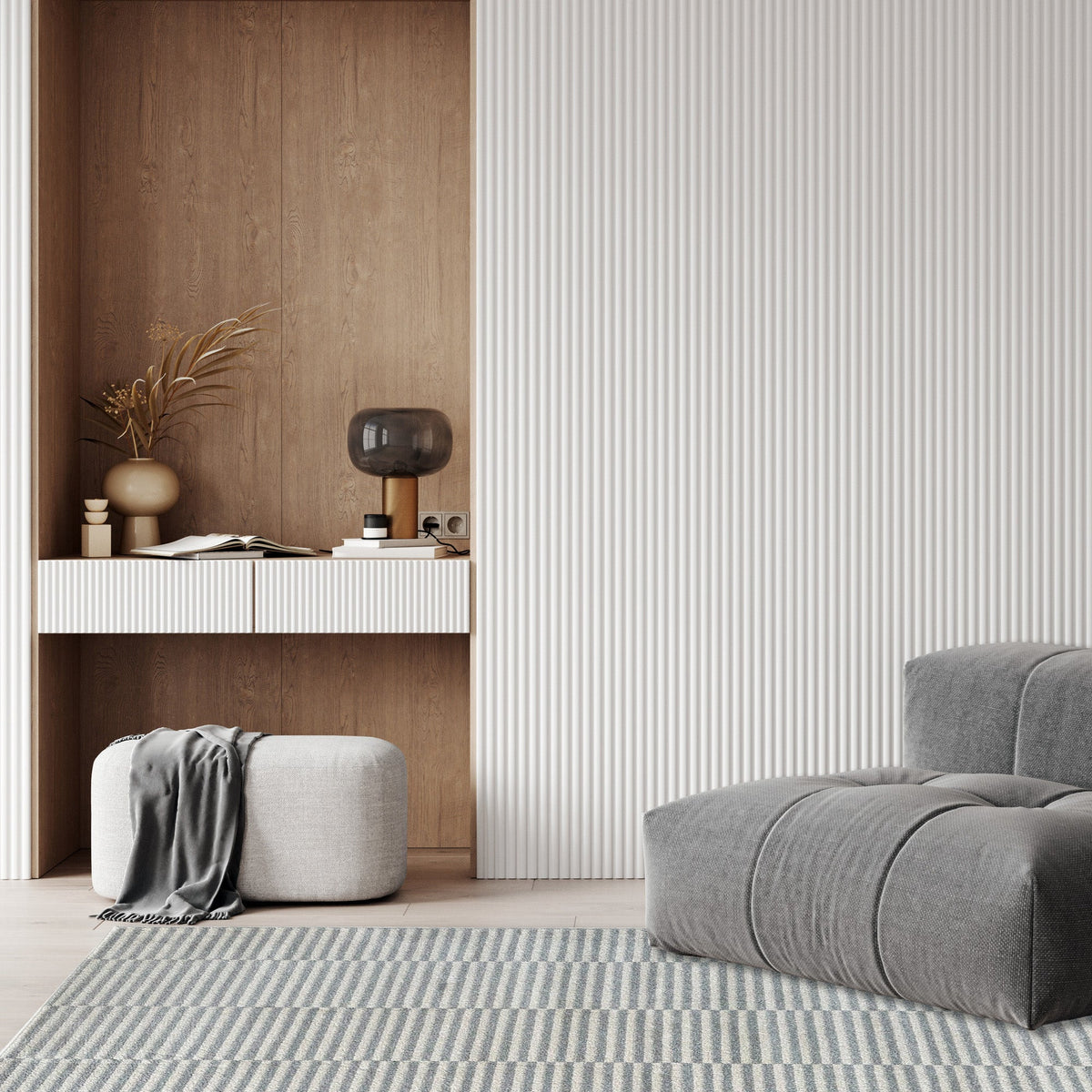 Cream and grey stripe rug in a living nook with timber panelling, a padded ottoman and a grey armchair