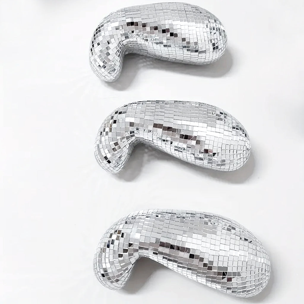 Three melting disco balls in small, medium and large stacked on a white background