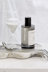 ECOYA Celebration room spray on marble tray with hourglass and wick trimmer in soft neutral styling
