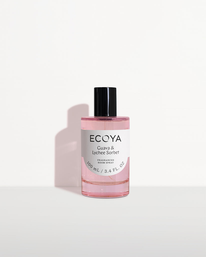 Ecoya room spray in pink glass with a black cap against a pale backdrop