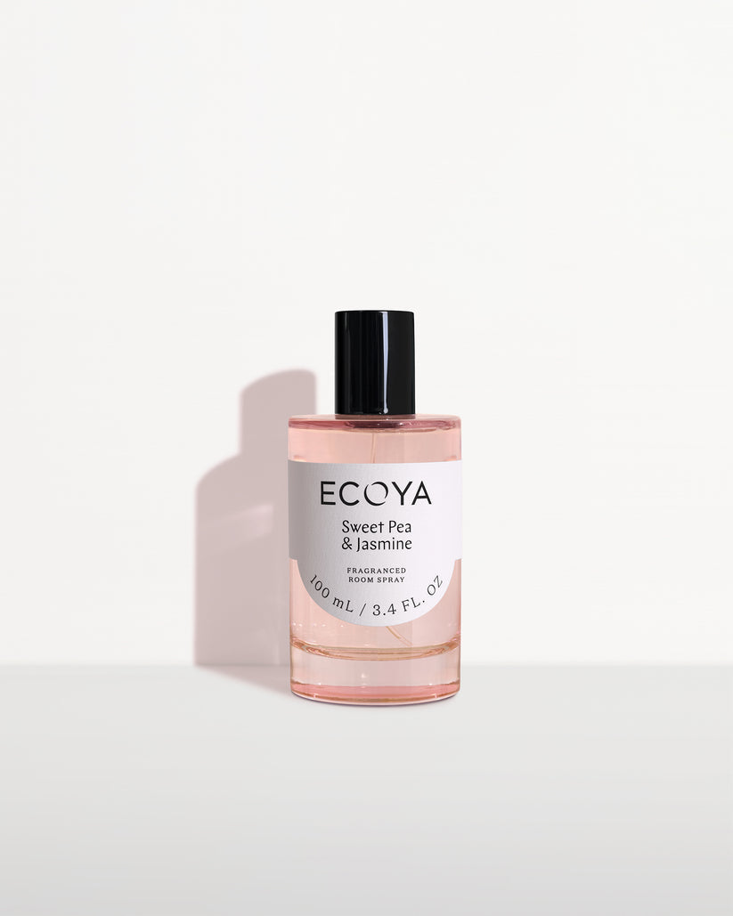 Ecoya room spray in blush pink glass with a black cap on white