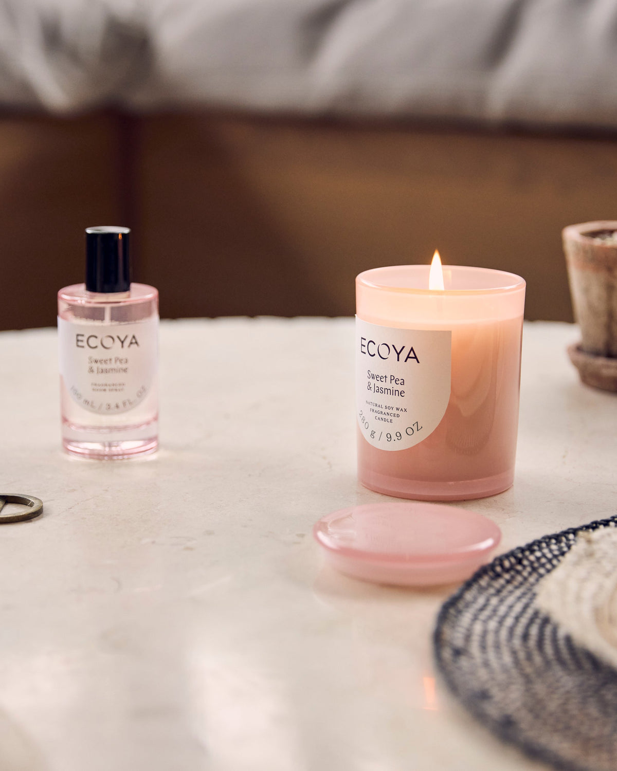 Ecoya Sweet Pea and Jasmine room spray and Metro candle styled on a marble table