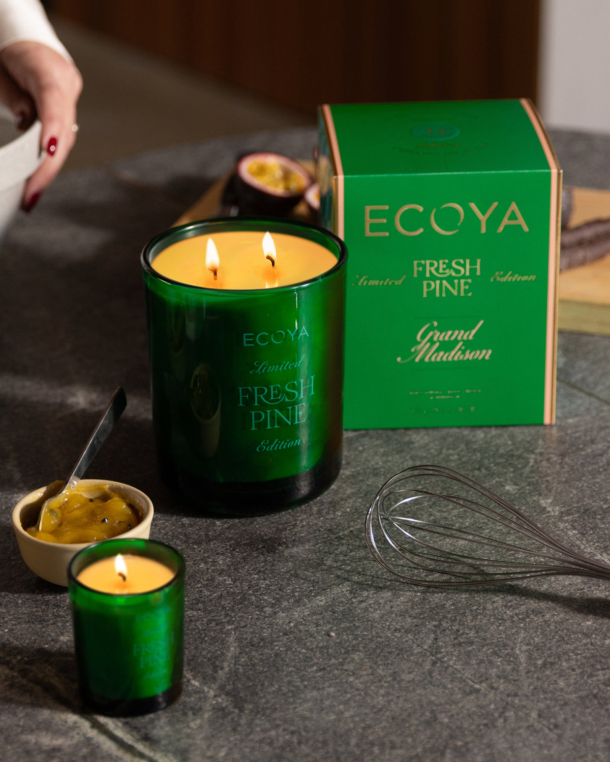 Ecoya Fresh Pine Grand Madison and mini candle lit beside the green carton