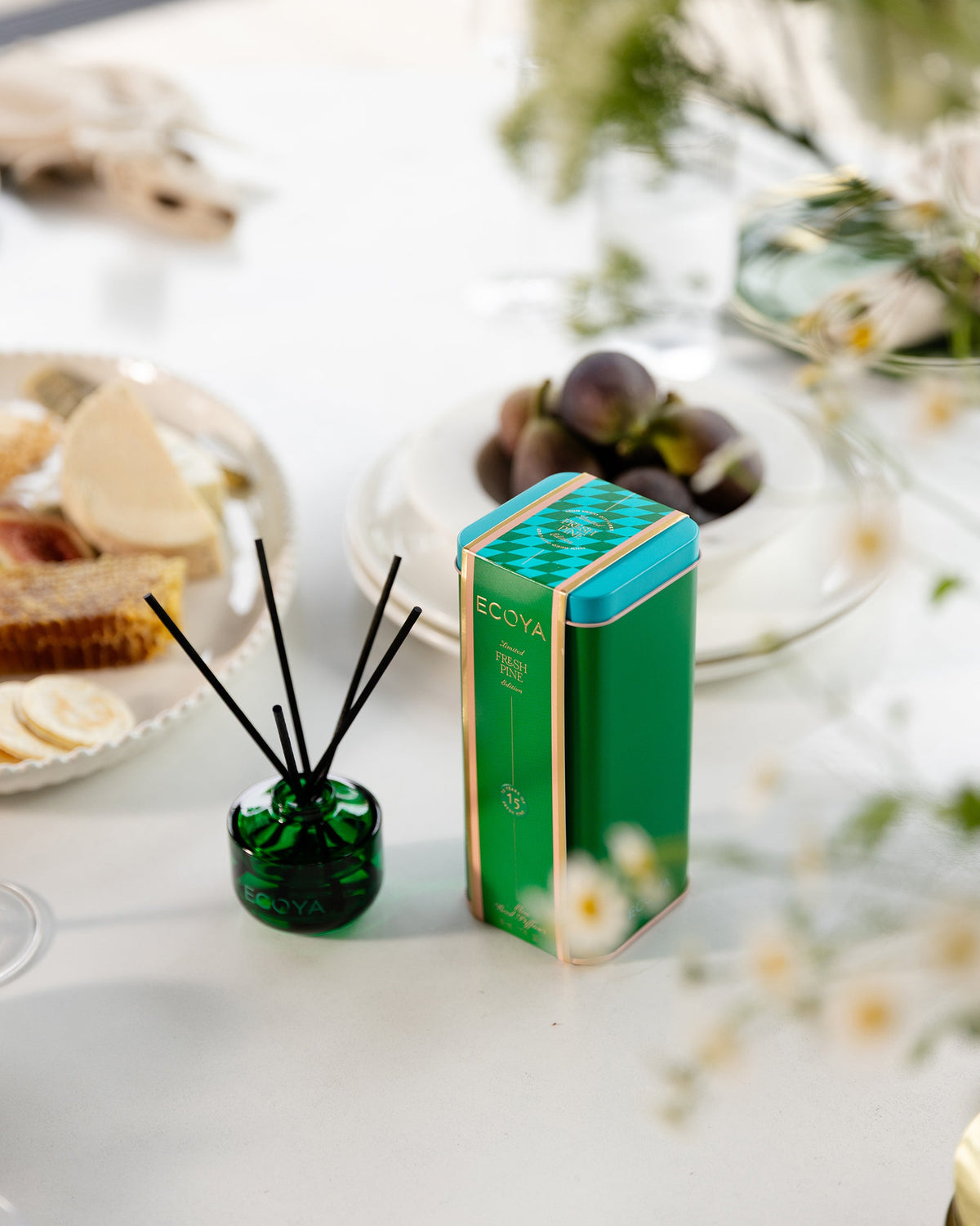 Ecoya Fresh Pine mini reed diffuser and tin on a white festive table