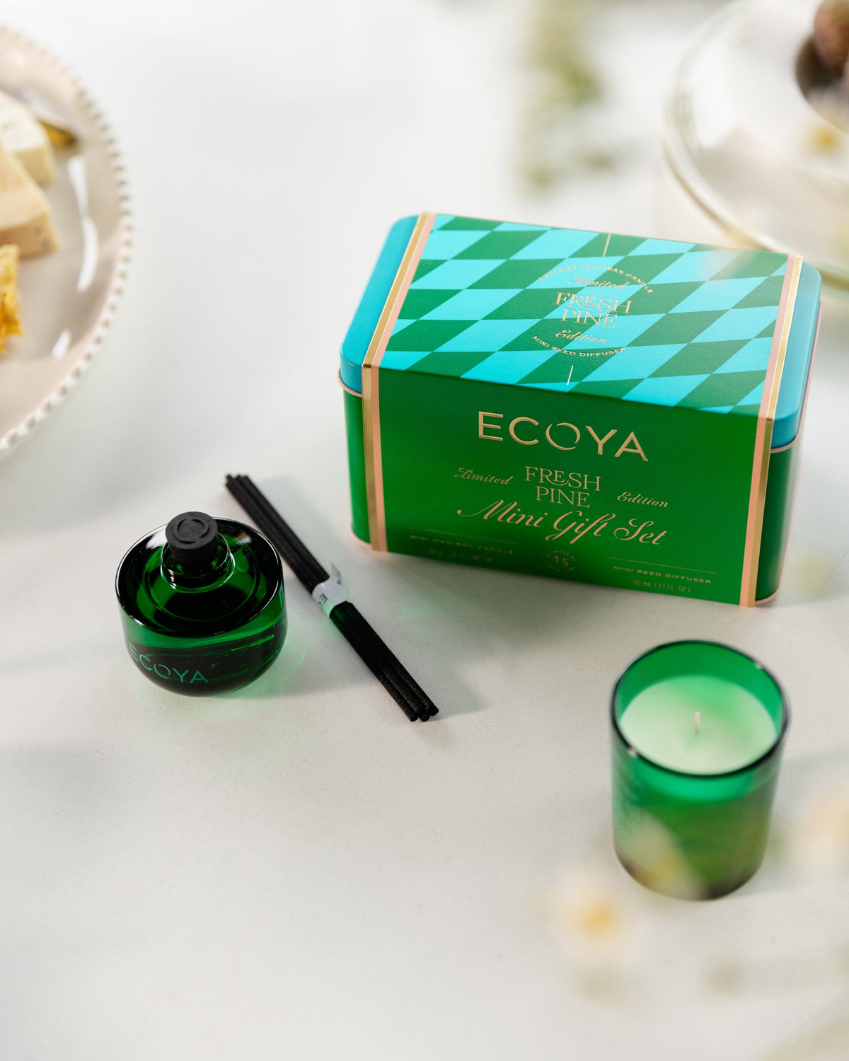 Ecoya Fresh Pine mini candle and diffuser beside the festive gift tin on a table
