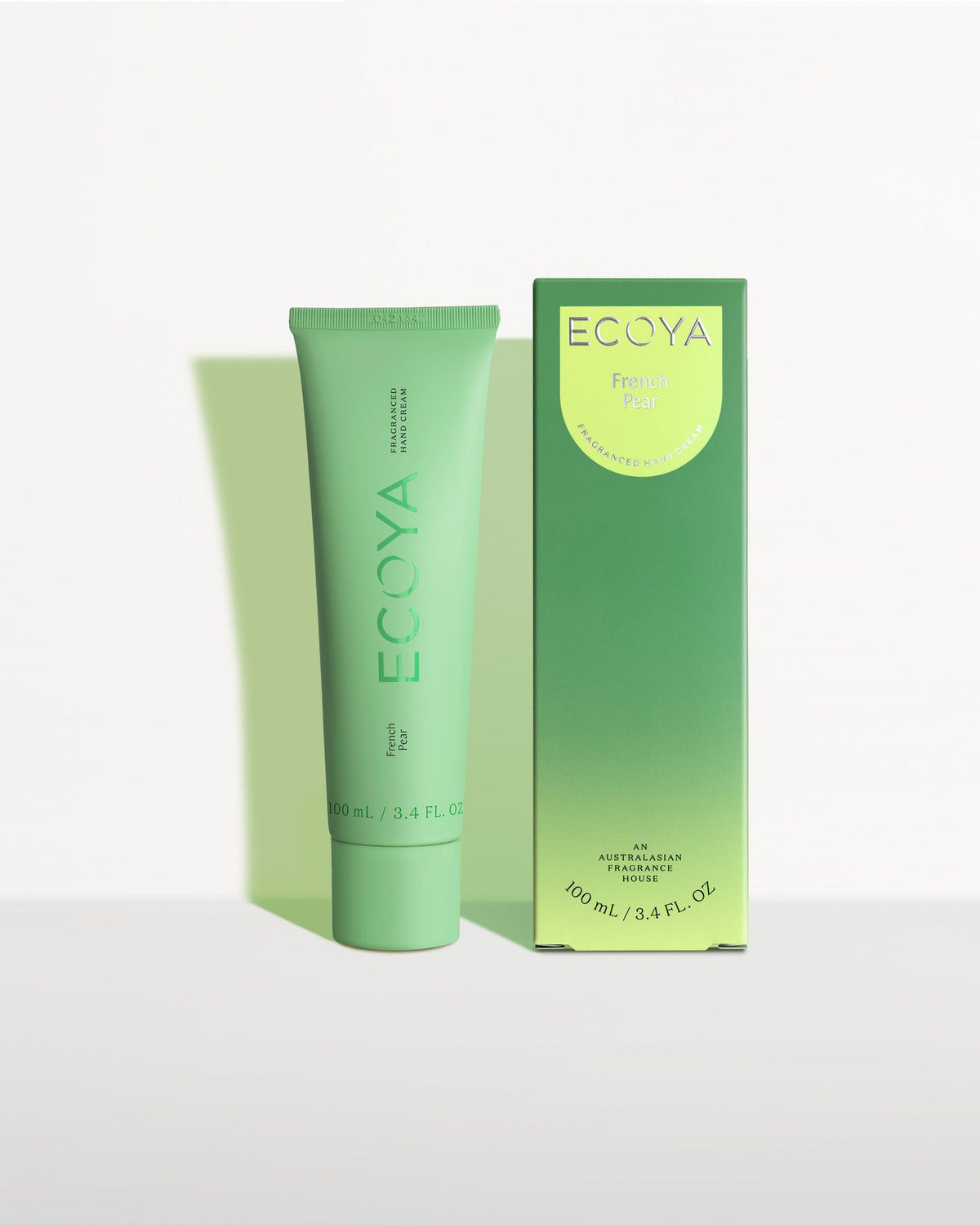 Ecoya hand cream in a green tube beside its green gradient box