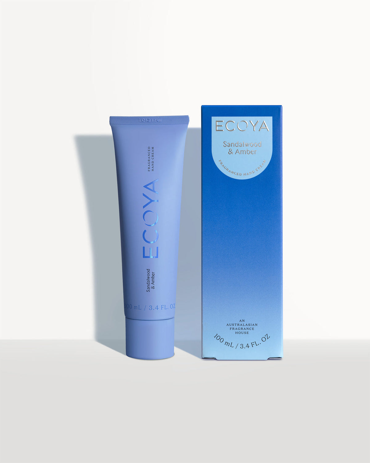 Ecoya hand cream in a blue tube beside its blue gradient box