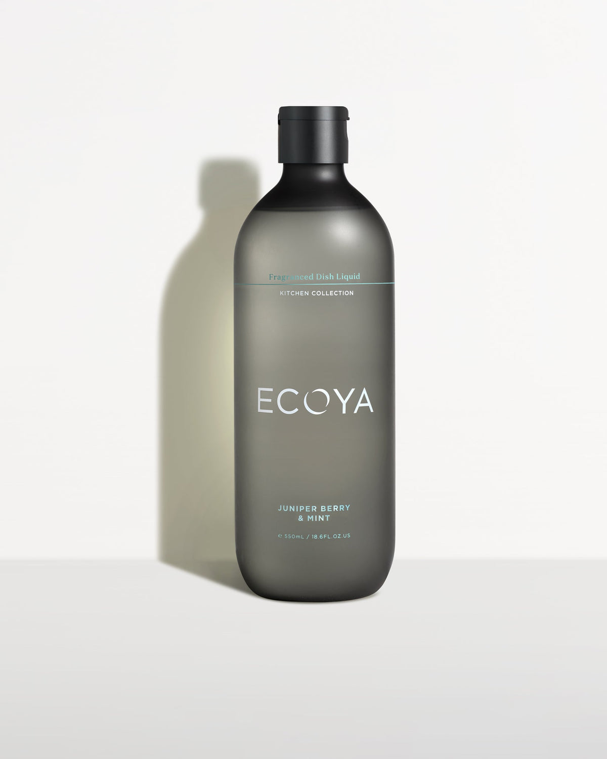 Ecoya dish liquid bottle in frosted grey, side-lit on a pale backdrop
