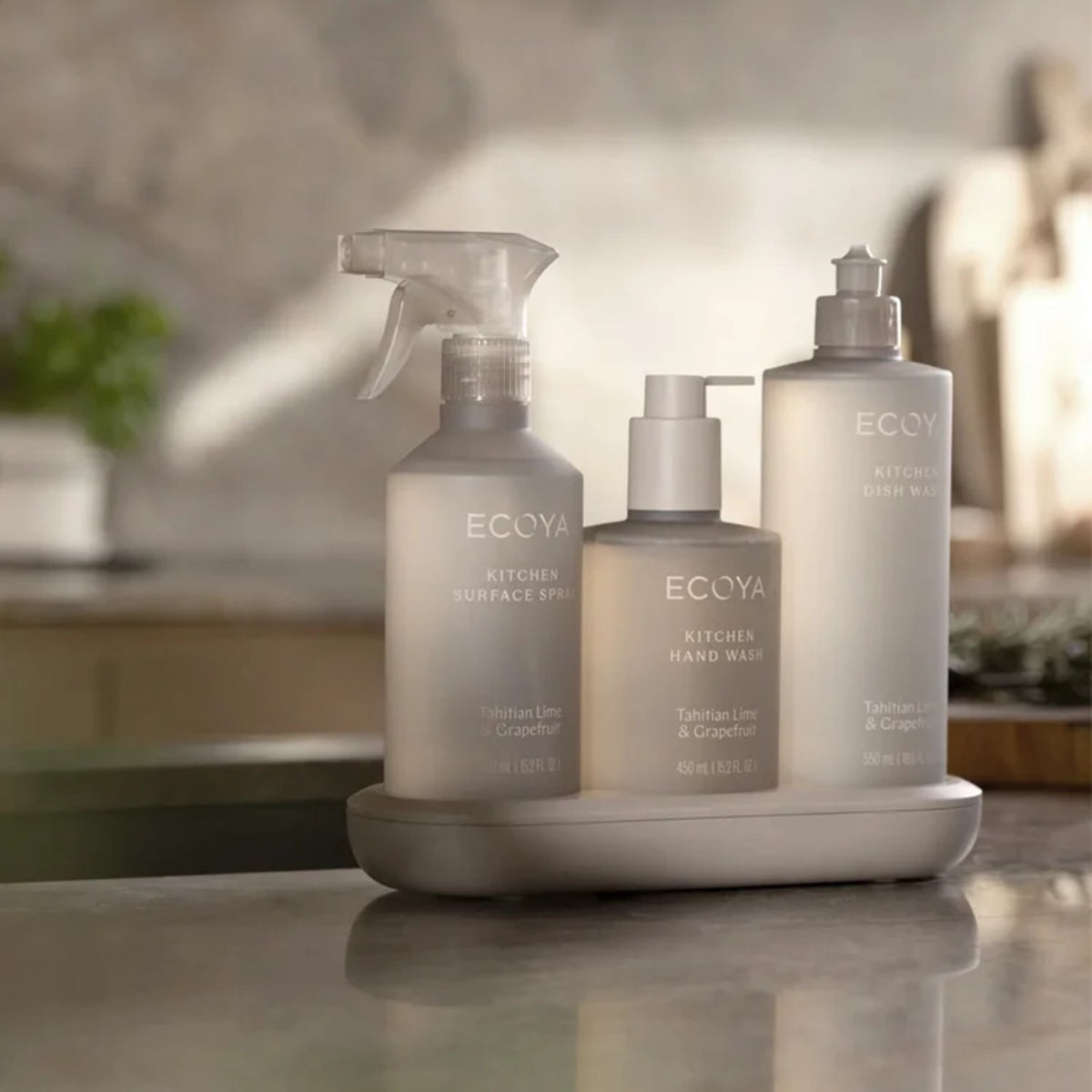 Ecoya Kitchen surface spray, hand wash and dish wash in Tahitian Lime and Grapefruit on a grey tray