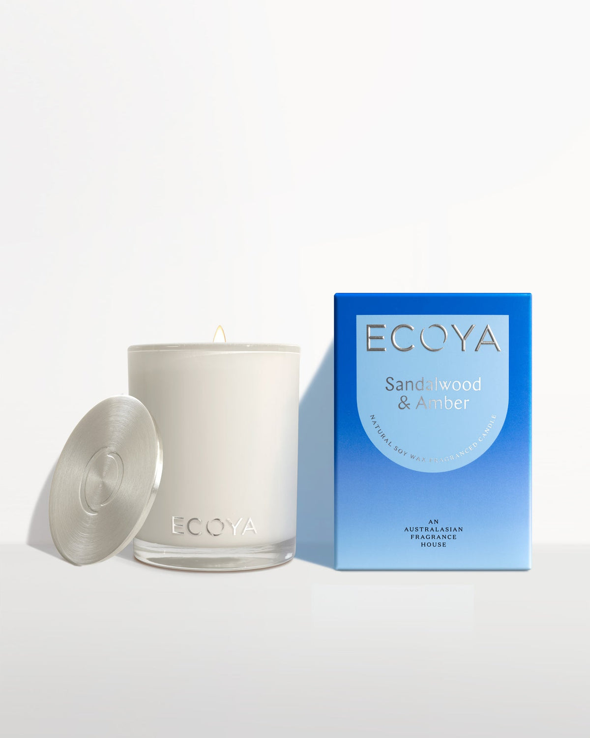 Ecoya Madison candle with the lid off beside its blue gift box
