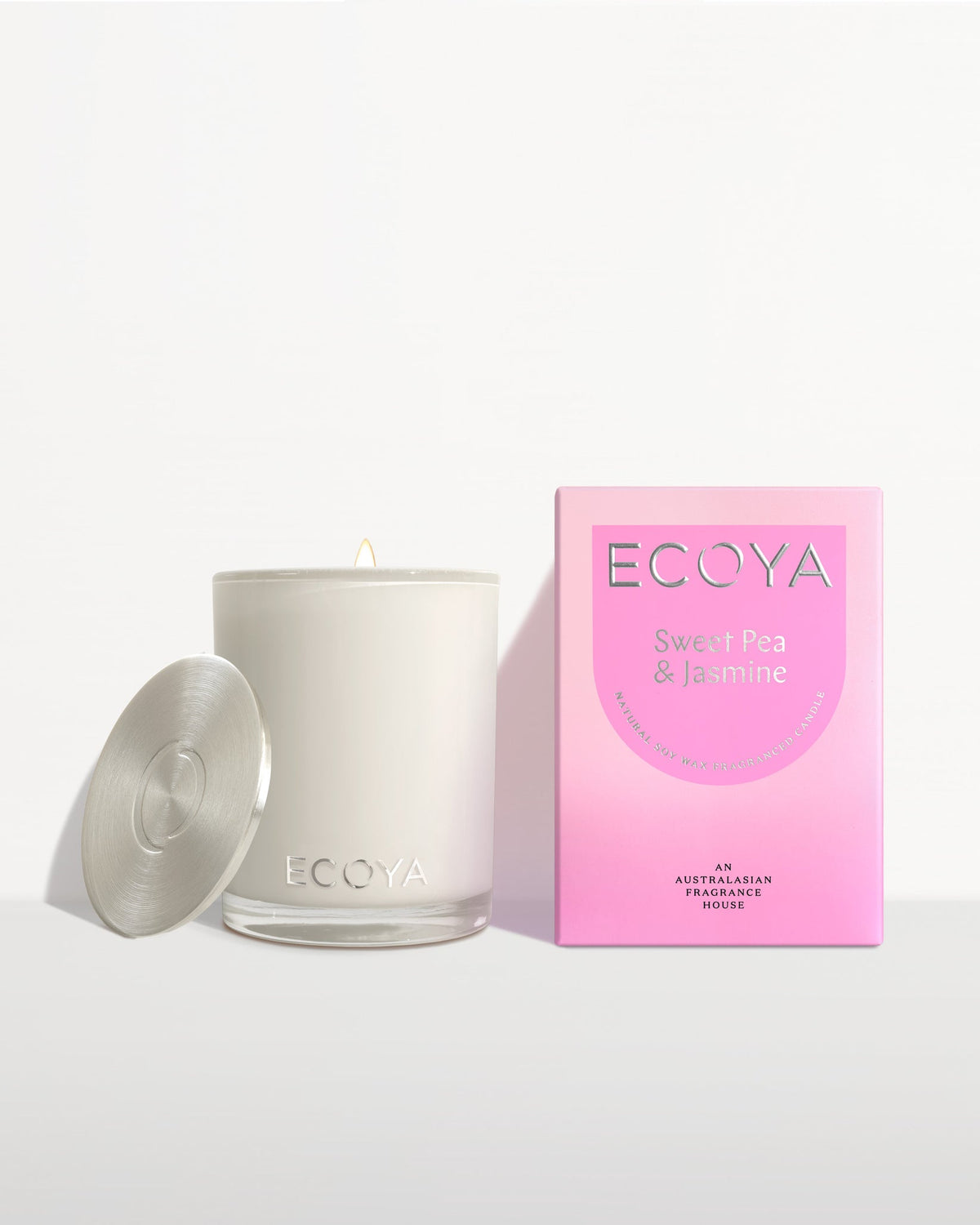 Ecoya Madison candle with the lid off beside its bright pink gift box