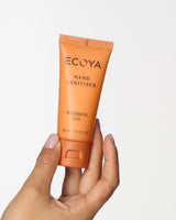 Hand holding the Ecoya Mandarin Gin Hand Sanitiser 40ml travel tube