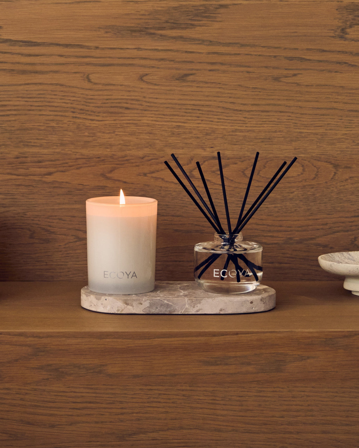 Ecoya Mini Duo candle and reed diffuser on a stone tray against a timber wall