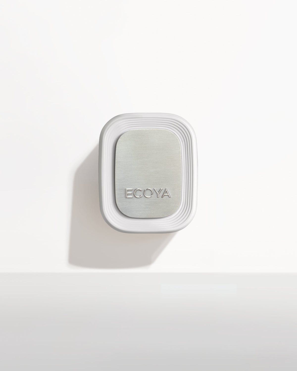 Front view of the Ecoya Plug-In Diffuser on a white wall with its brushed metallic faceplate