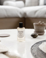 Ecoya Mandarin Gin room spray styled on neutral coffee table in minimalist living room