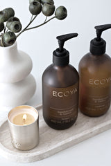 Ecoya Sandalwood & Amber Shampoo & Conditioner set styled with candle – luxury haircare duo with nourishing oils