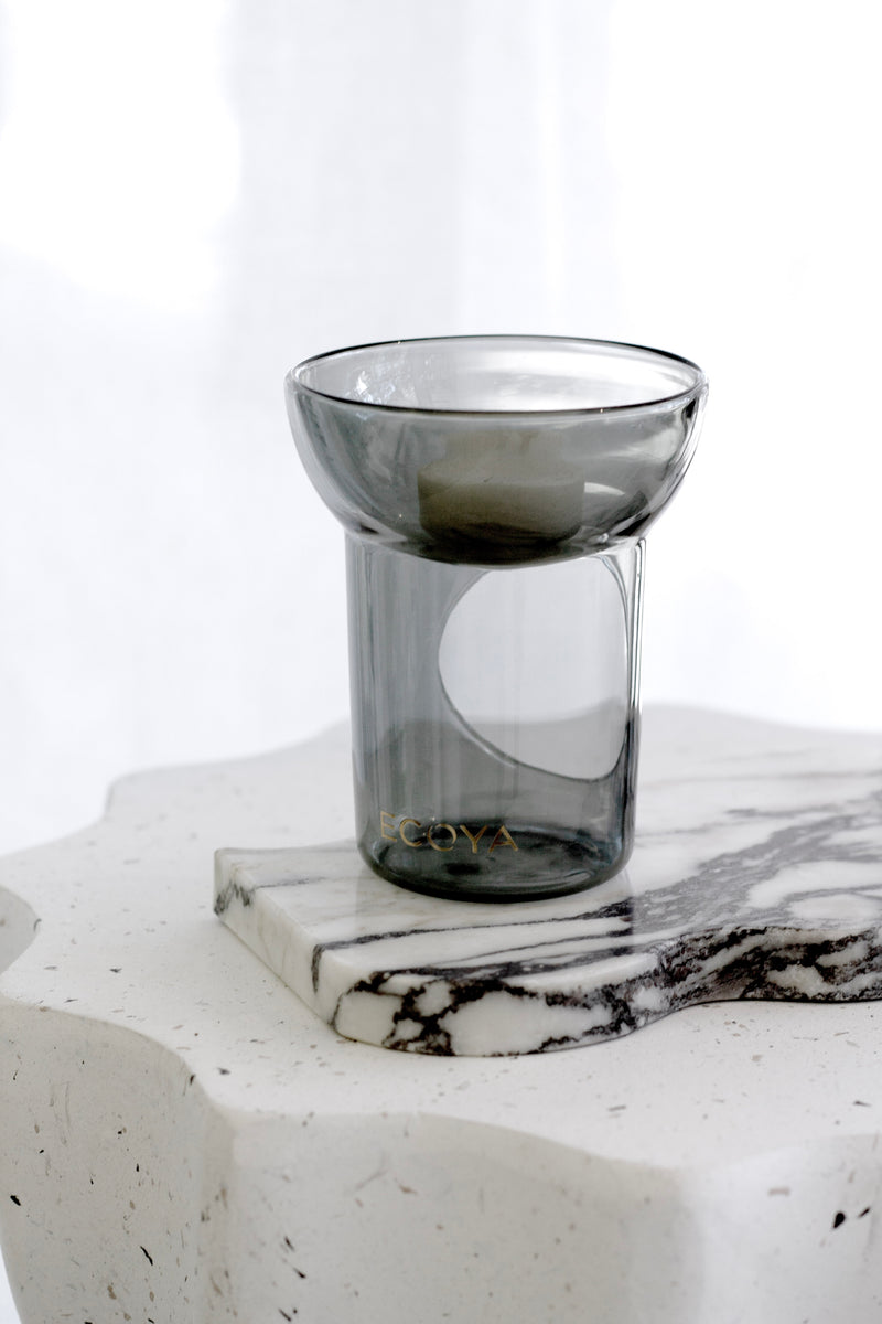 Ecoya soy melt lantern in smoked glass with Bamboo & White Lily melt; styled on marble side table for home fragrance.