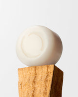 ECOYA Soy Wax Melt ceramic disc balanced on a natural timber block on a neutral background.