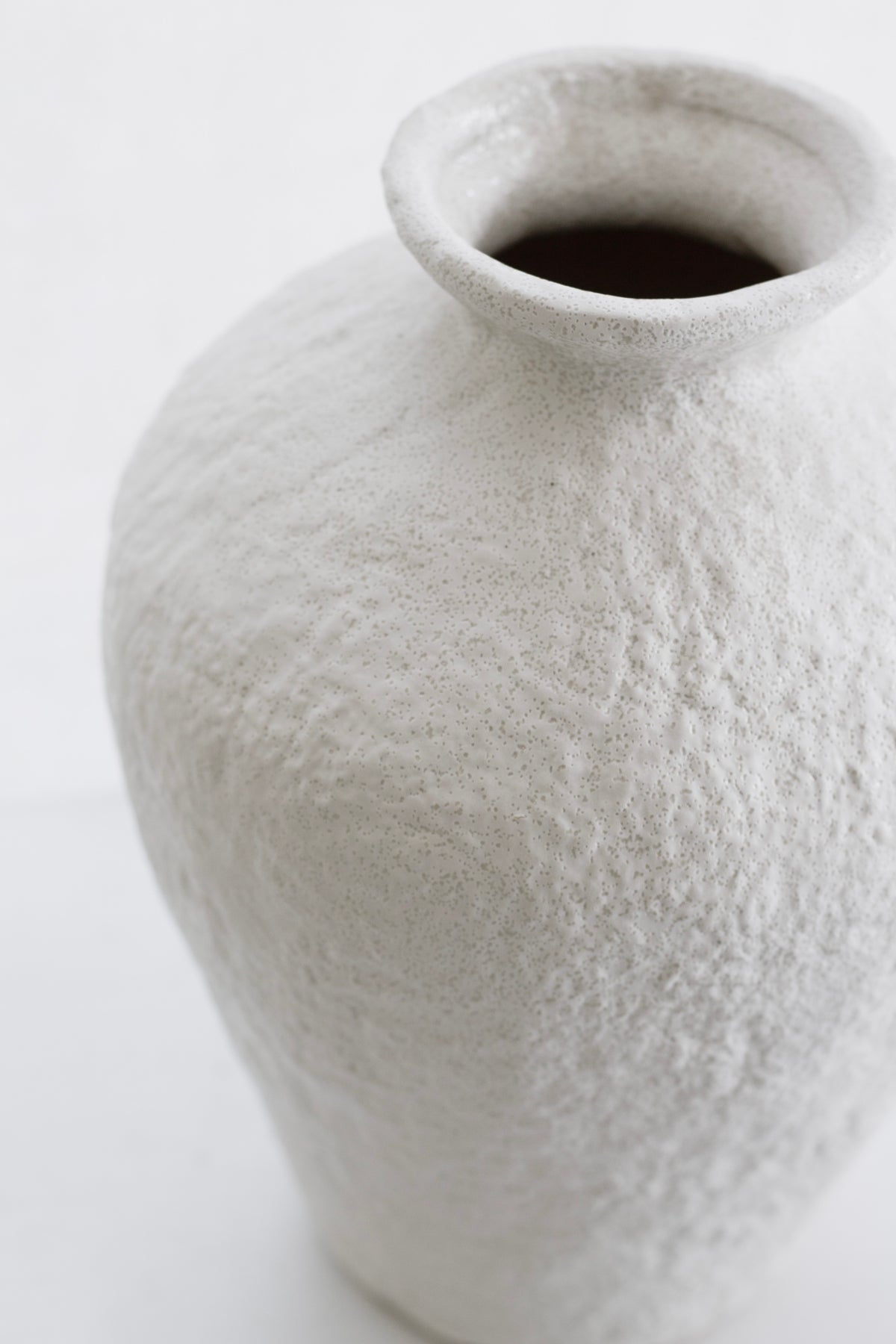 Close-up of the Lyra vase's textured shoulder and flared neck